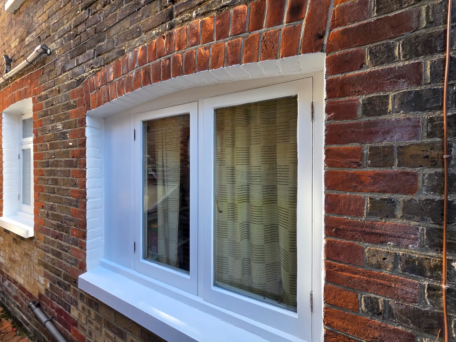 Rear casement window finished in white gloss