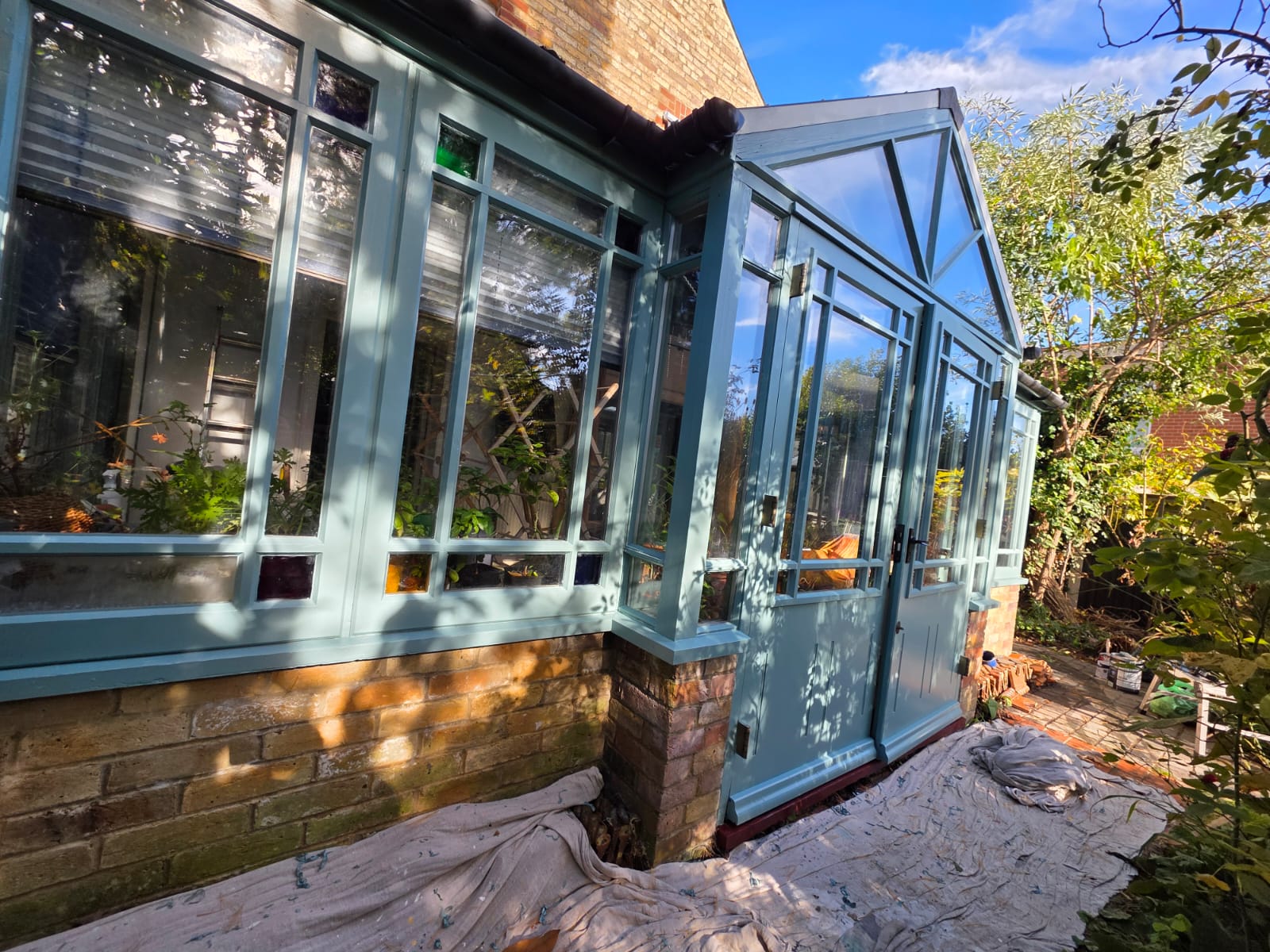 Conservatory frames and glazing bars repainted in sage green