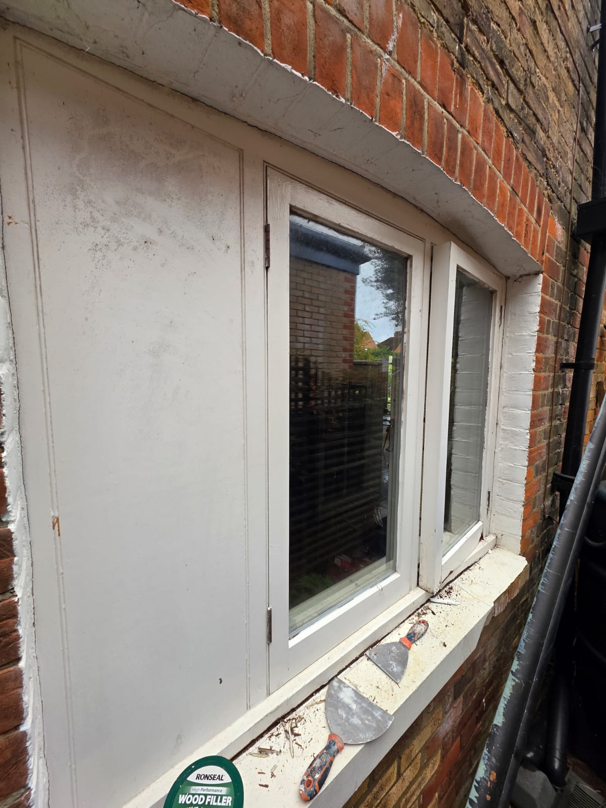 Window and door frame before, with flaking paint