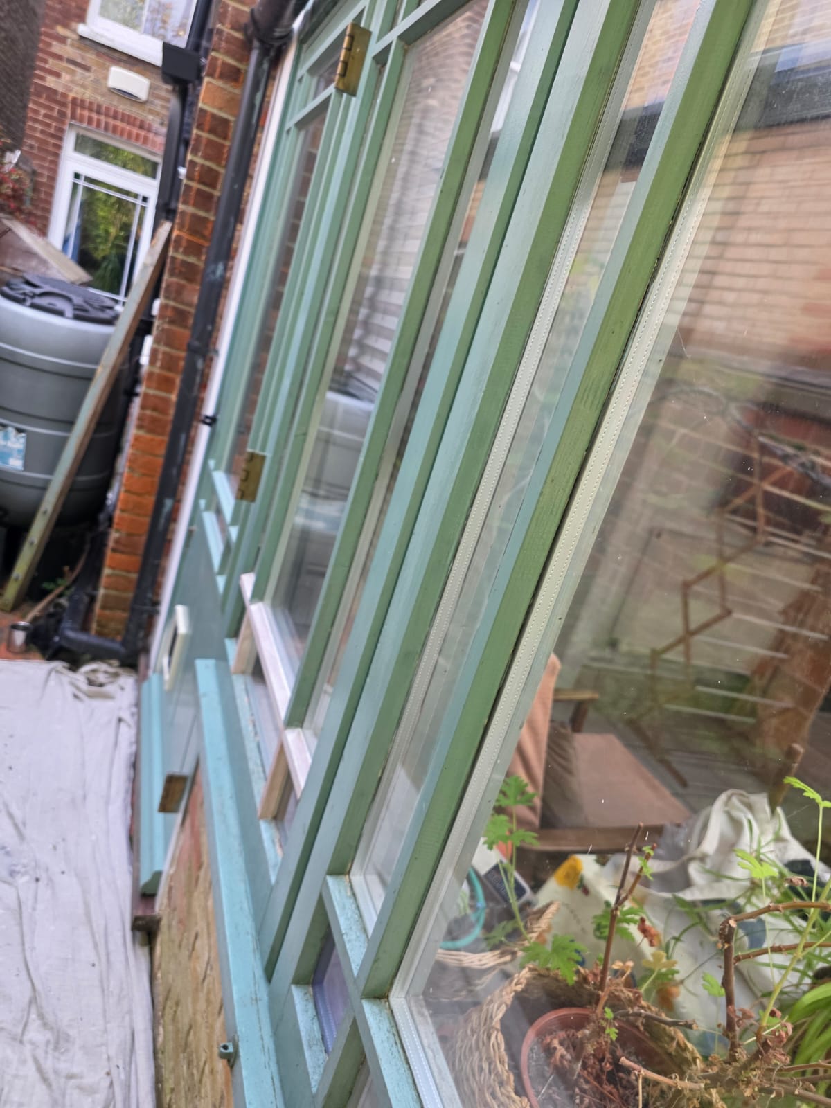 Conservatory glazing bars before, with faded paint