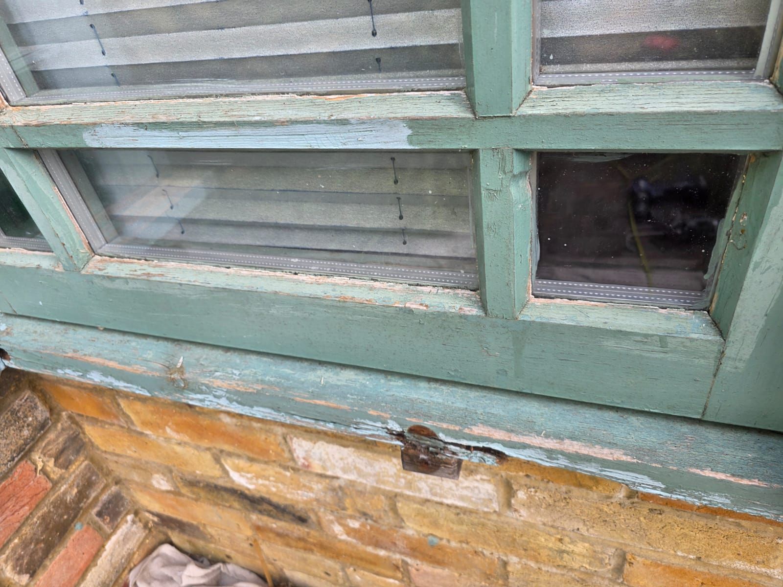 Bottom rail before, with flaking paint