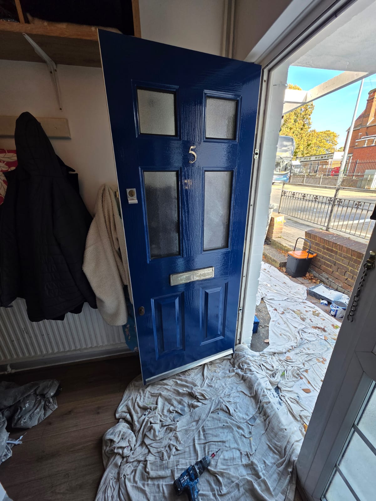 Front door finished in high-gloss blue