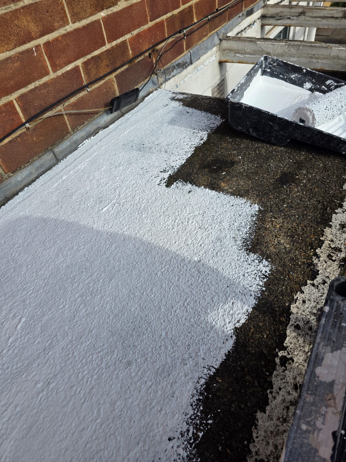 Flat roof being coated