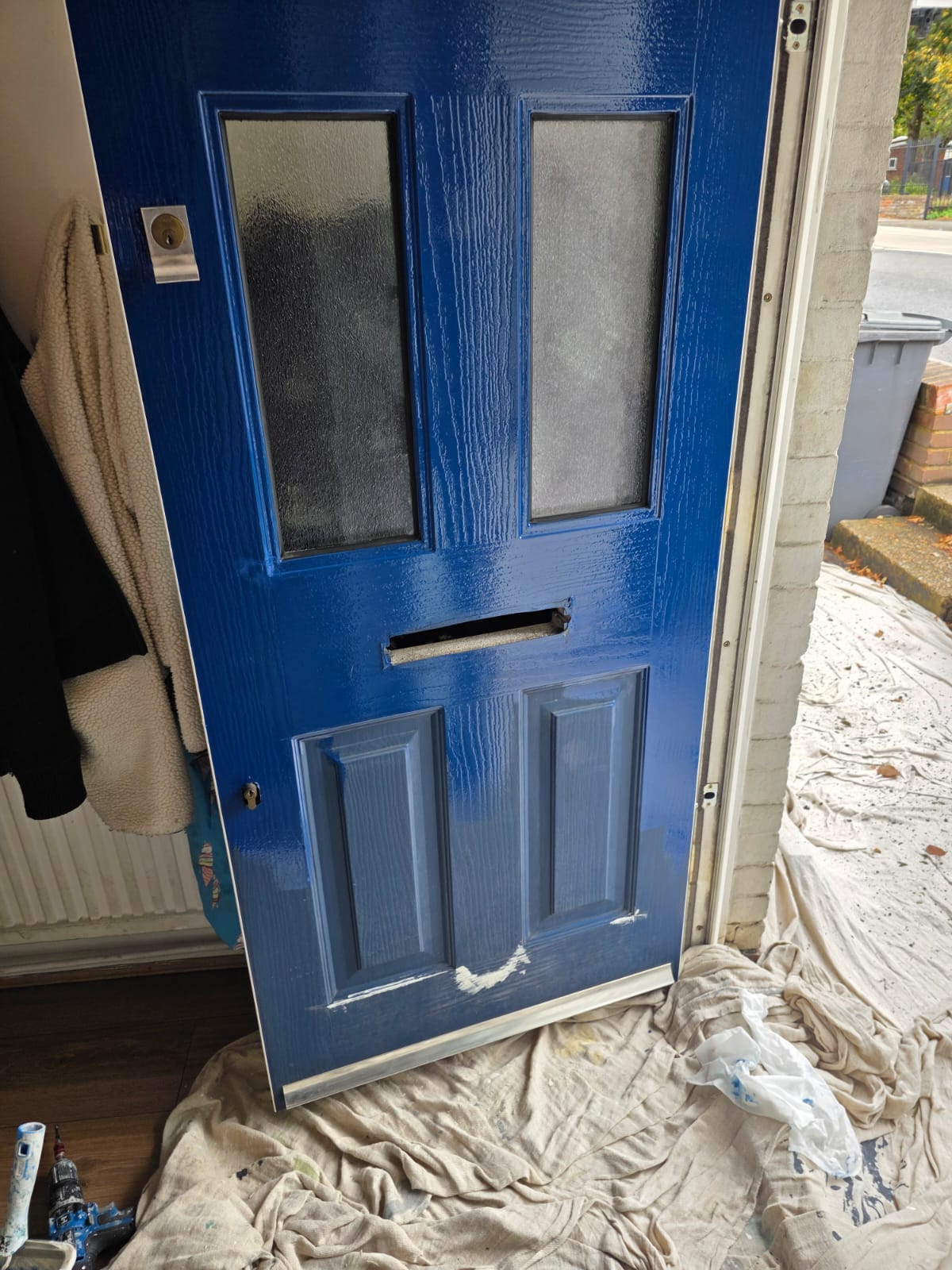 Front door during painting, with floors sheeted