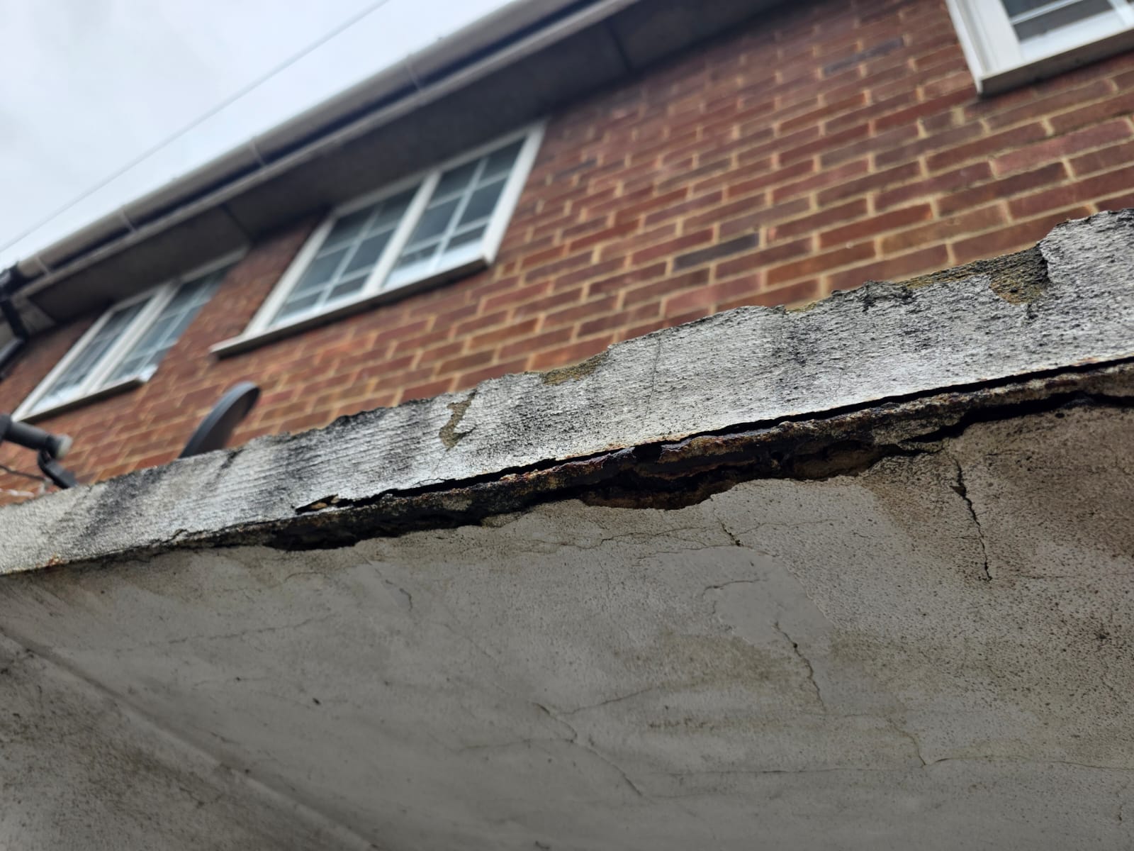 Concrete canopy before, with cracked and broken edges