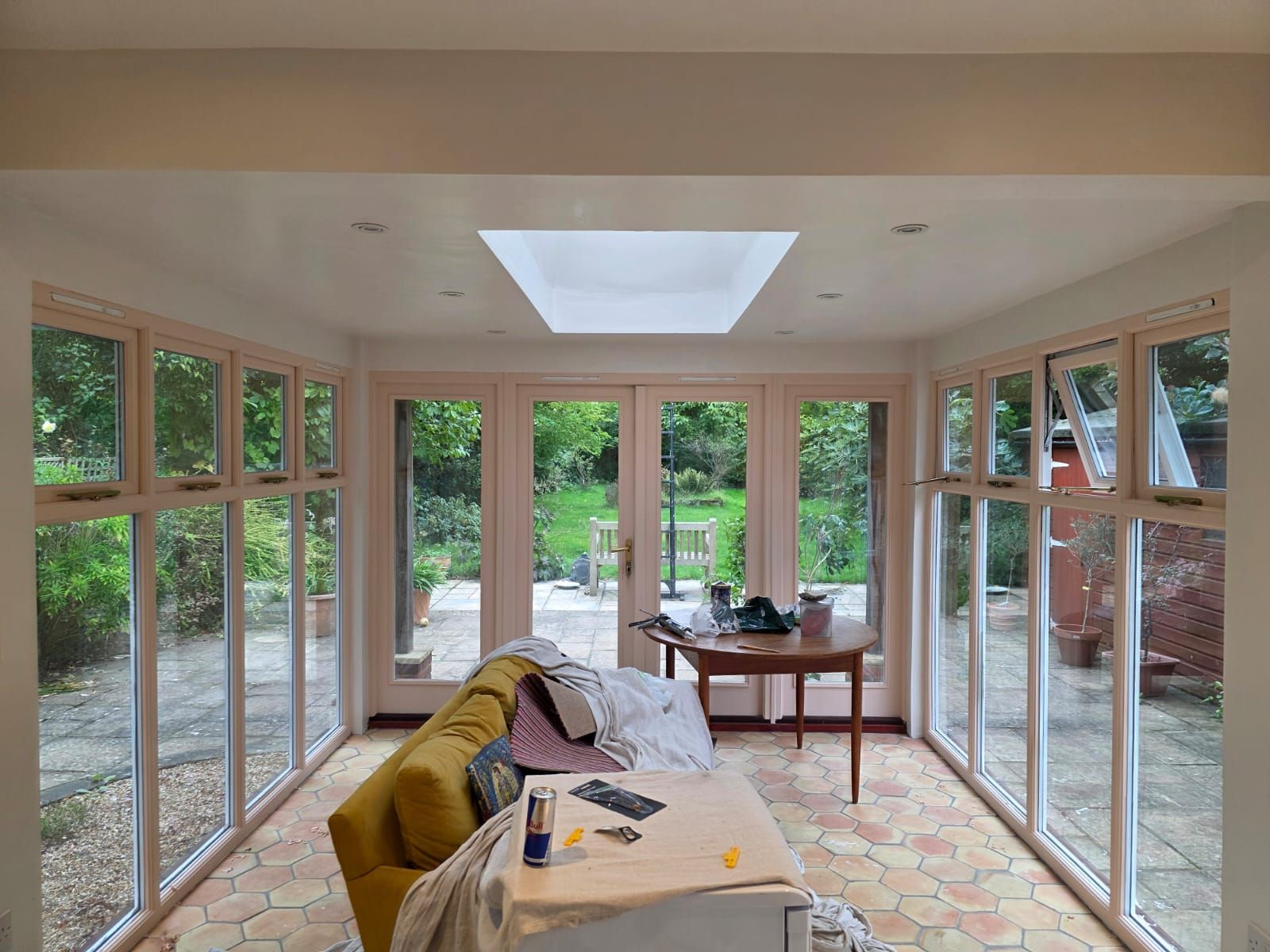 Garden room finished, with timber windows and doors in soft plaster pink
