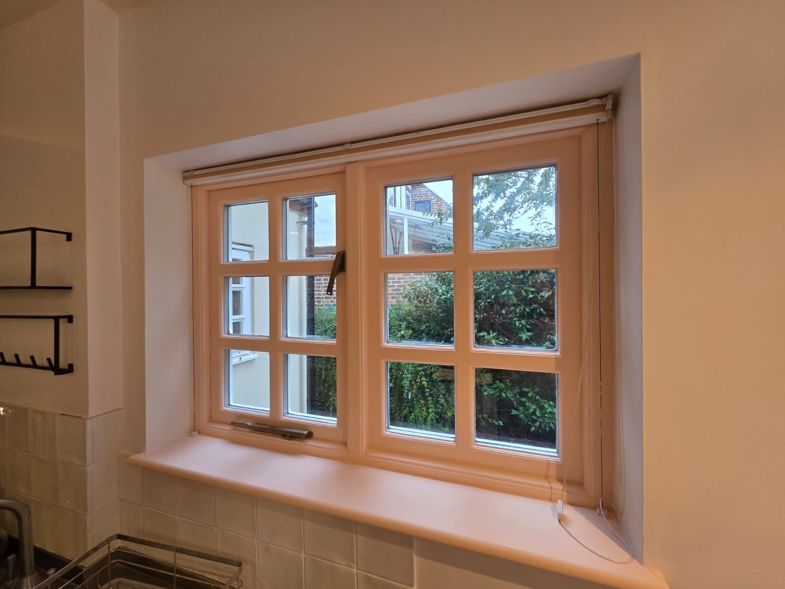 Kitchen window frame finished in soft plaster pink