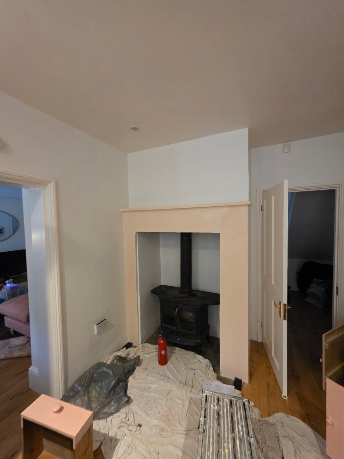 Living room with wood burner, during the job