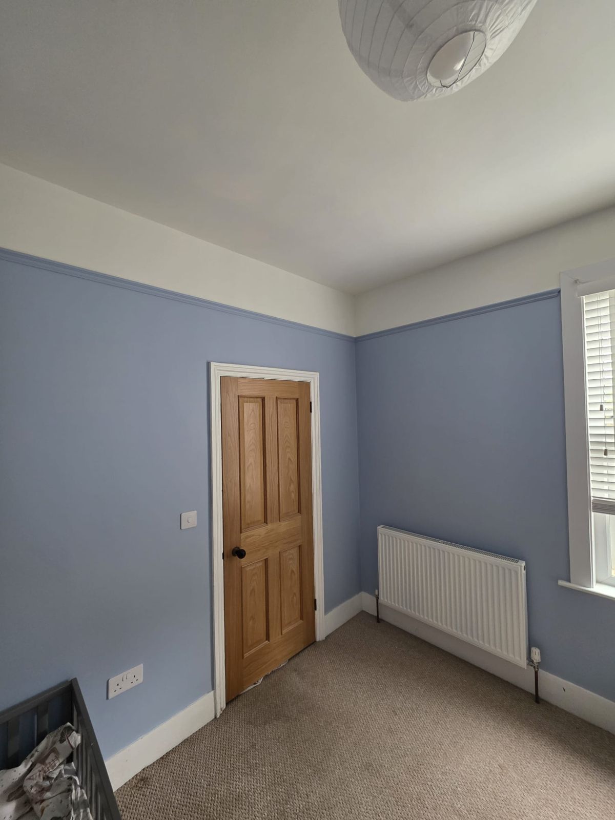 Bedroom finished in soft blue with white ceiling