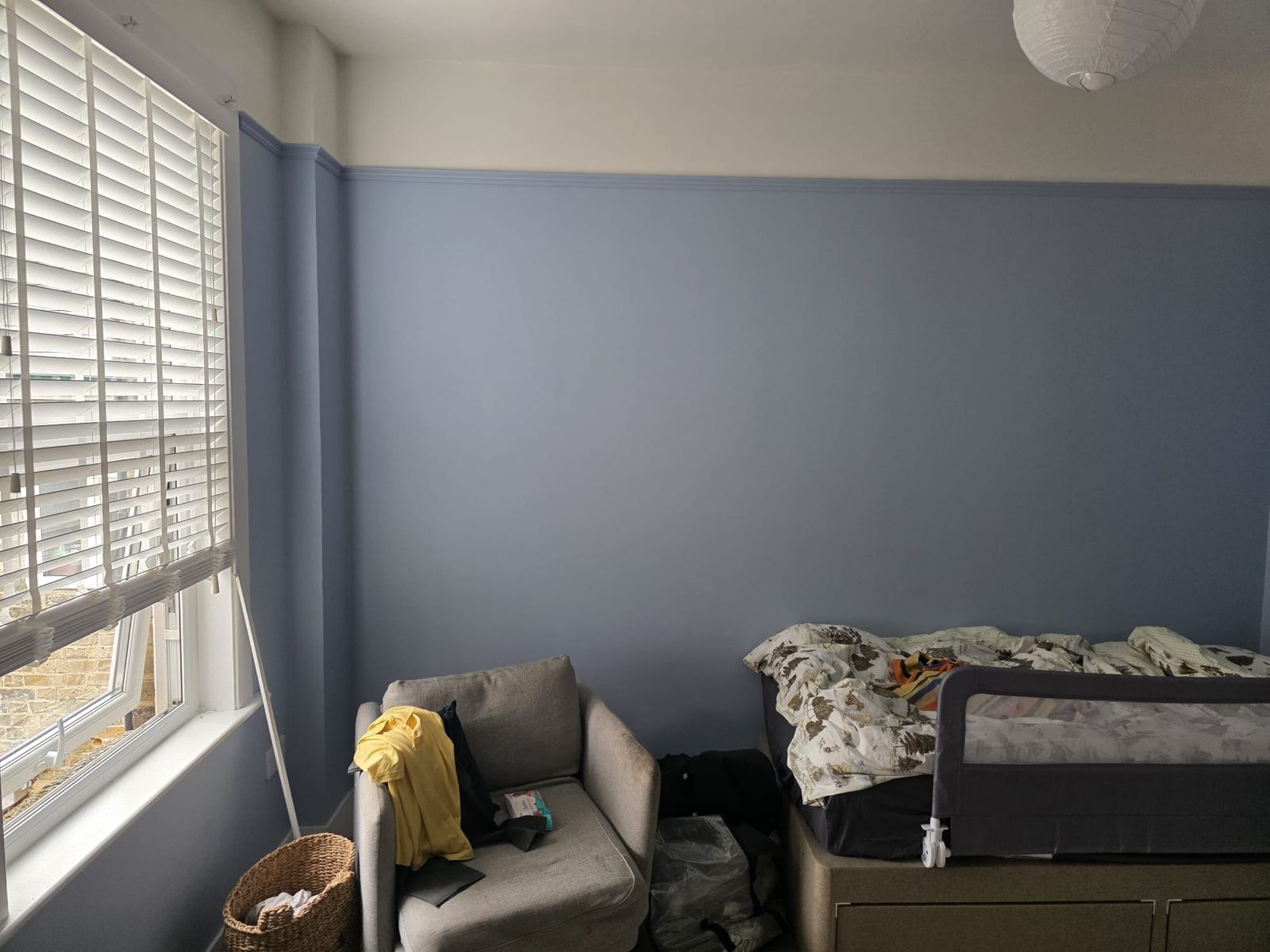 Soft blue bedroom with white woodwork