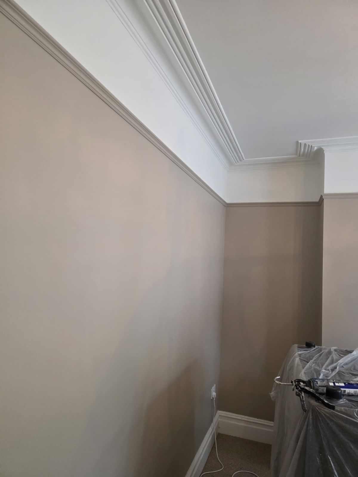 Corner of the bay-fronted room in a warm neutral