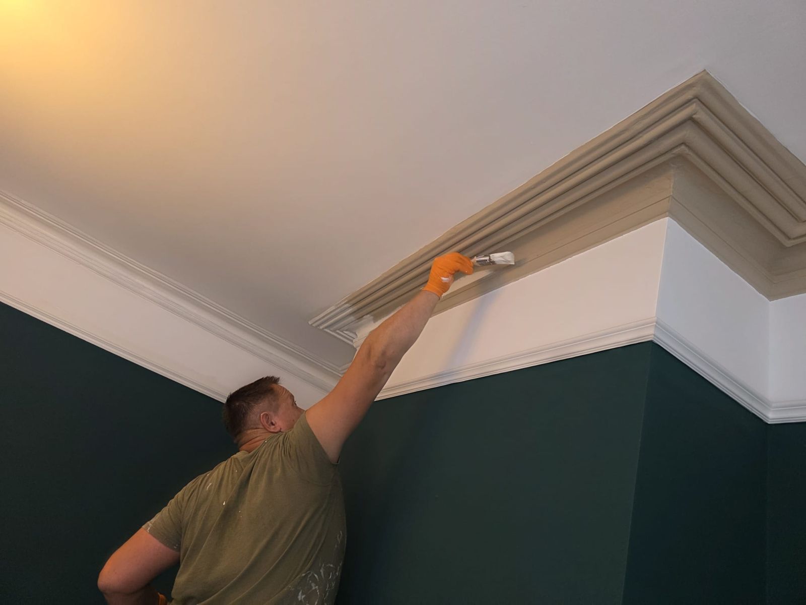 Painting the cornice in the bay-fronted room