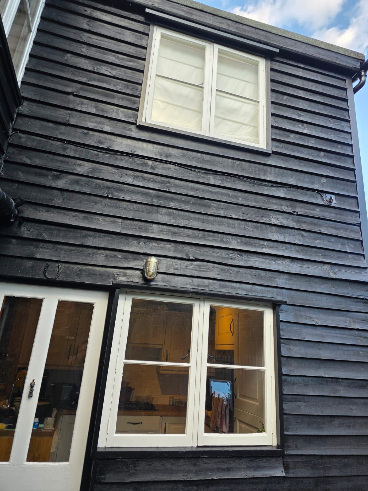 Rear wall with white windows and door